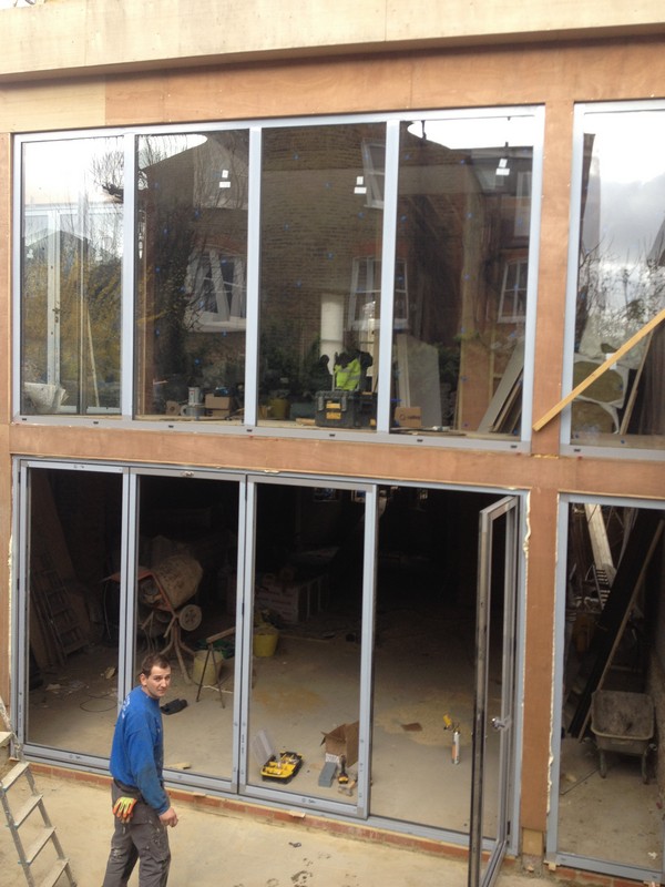 Aluminium bi-fold doors with two-storey glazing in Mile End