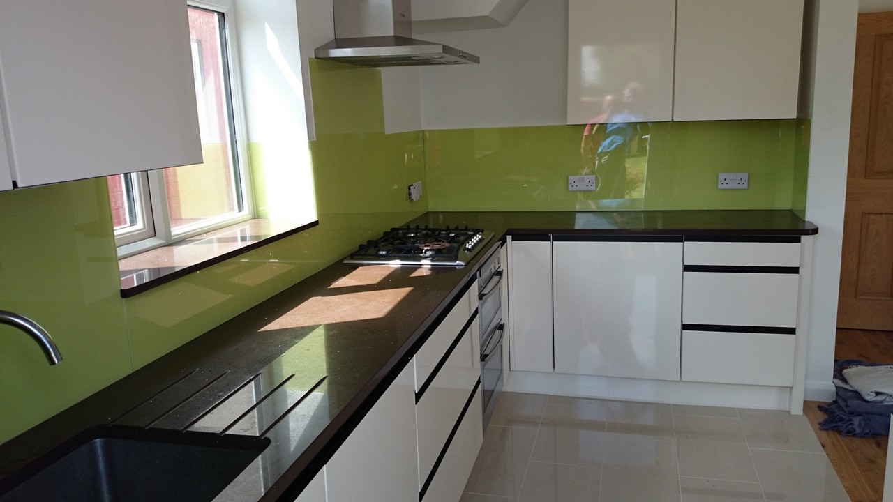 Lime green glass kitchen splashback installed by Mile End glaziers