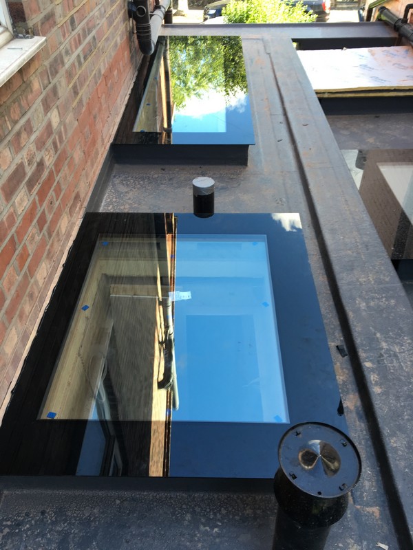 Multiple flat roof skylights on extension in Mile End