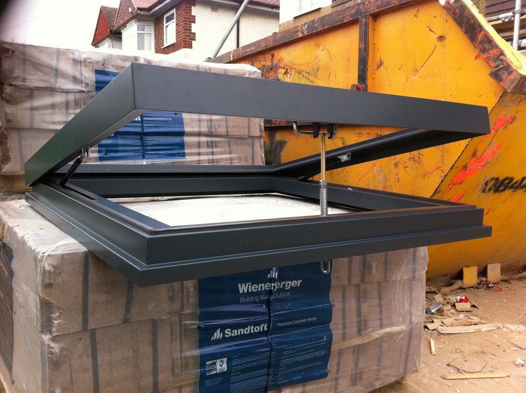 Opening flat roof skylight in anthracite grey installed in Mile End