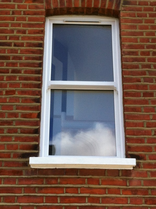 uPVC sash window on Victorian red brick house in Mile End